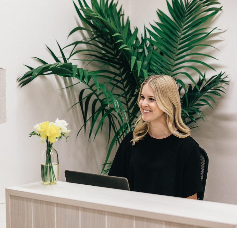 Receptionist at a Ray White Bell Group office